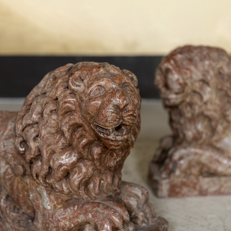 A pair of Florentine renaissance style red and grey marble lions